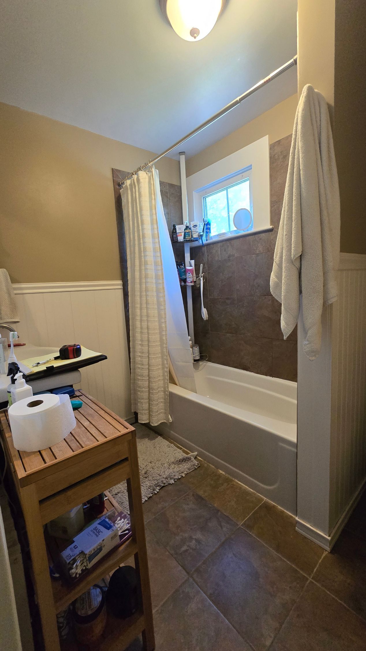 Newington CT bathroom with a built-in jacuzzi tub, dark blue walls, and a sunset painting above the tub.