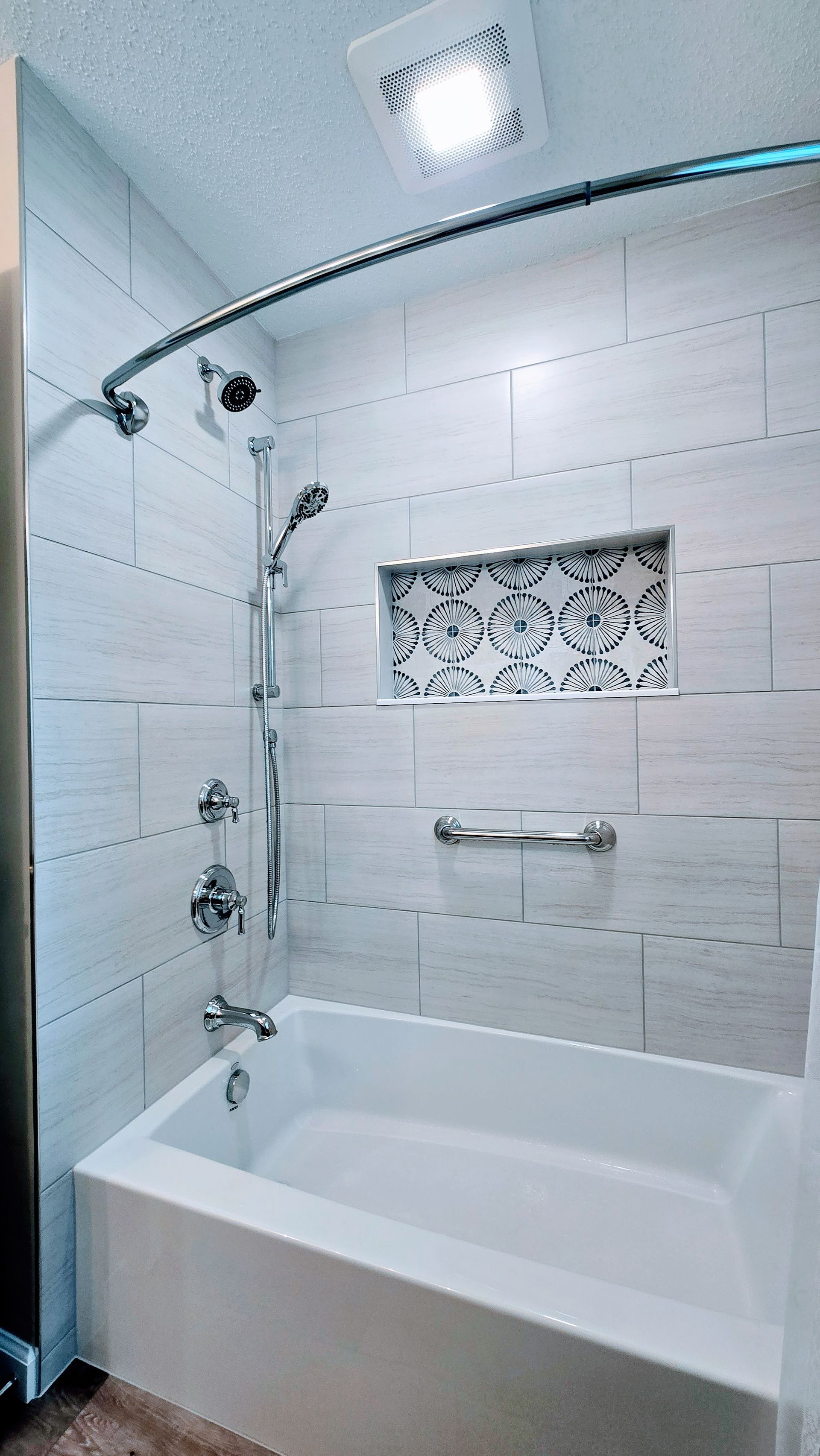 A bathroom with a bathtub and a shower.