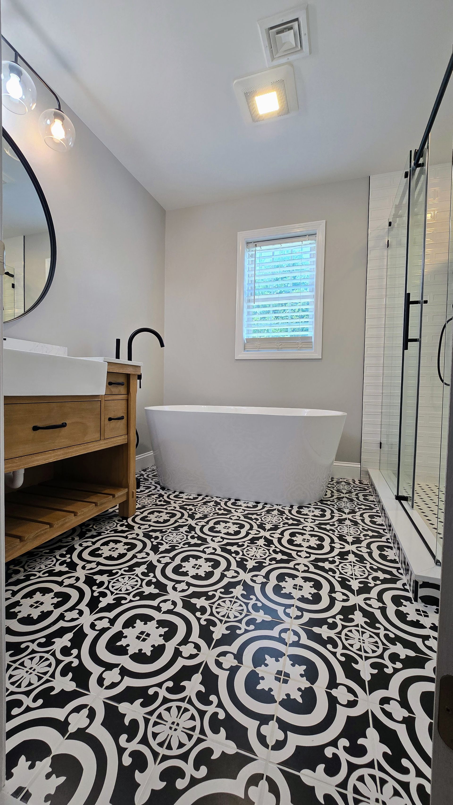 A Southington bathroom with a bathtub , sink , mirror and shower.
