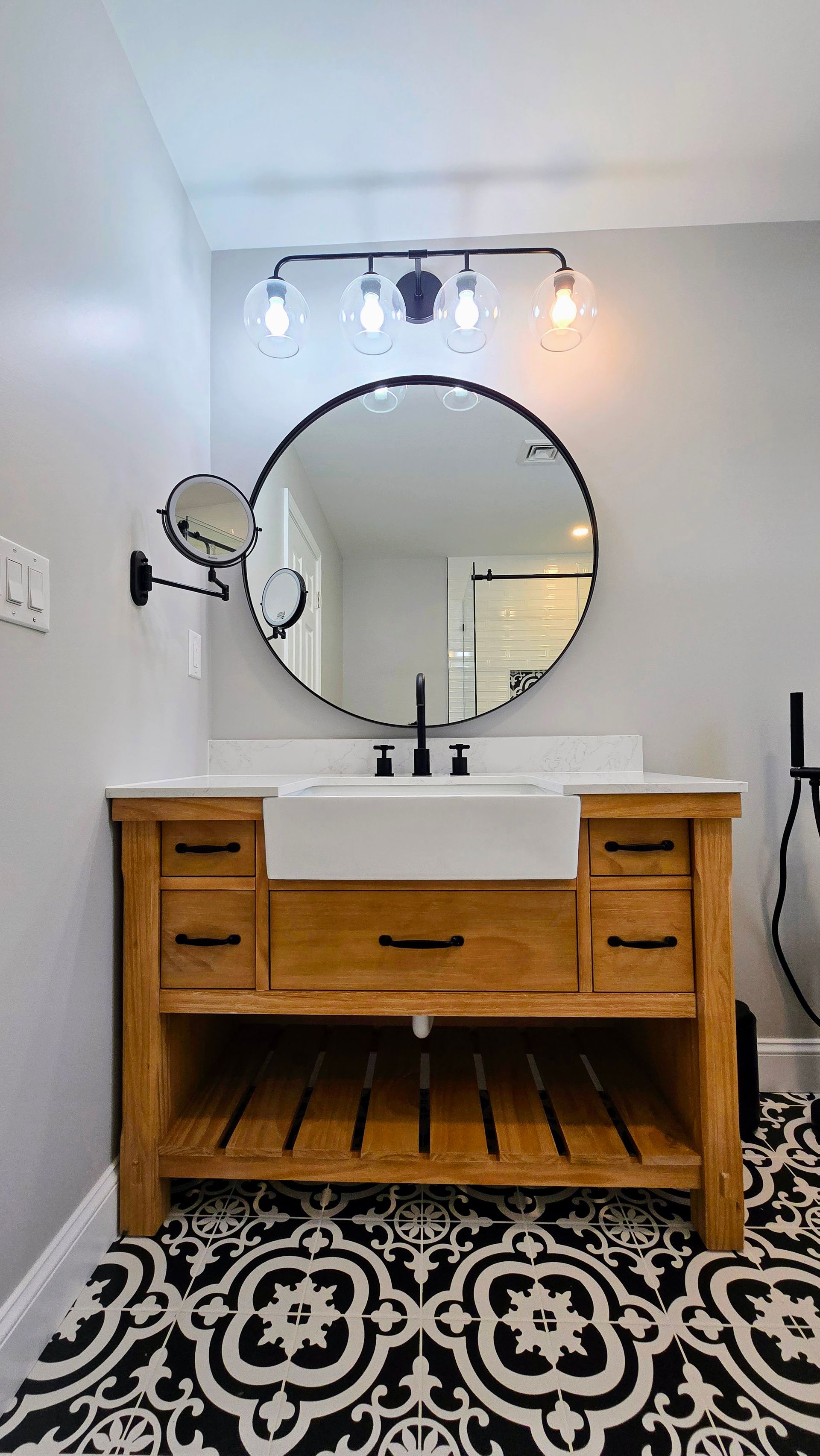 A Southington bathroom with a sink , mirror , and tile floor.