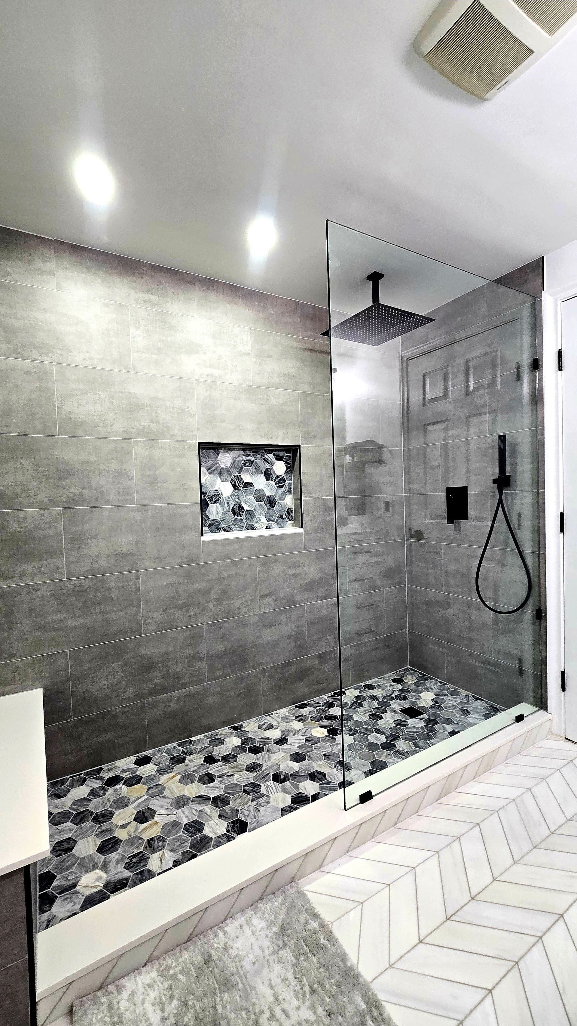 A bathroom with a bathtub and a shower.