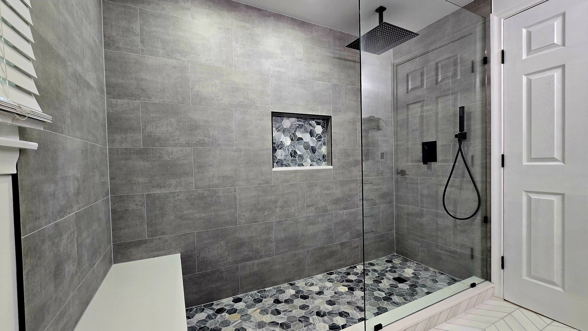 A bathroom with a bathtub and a shower head