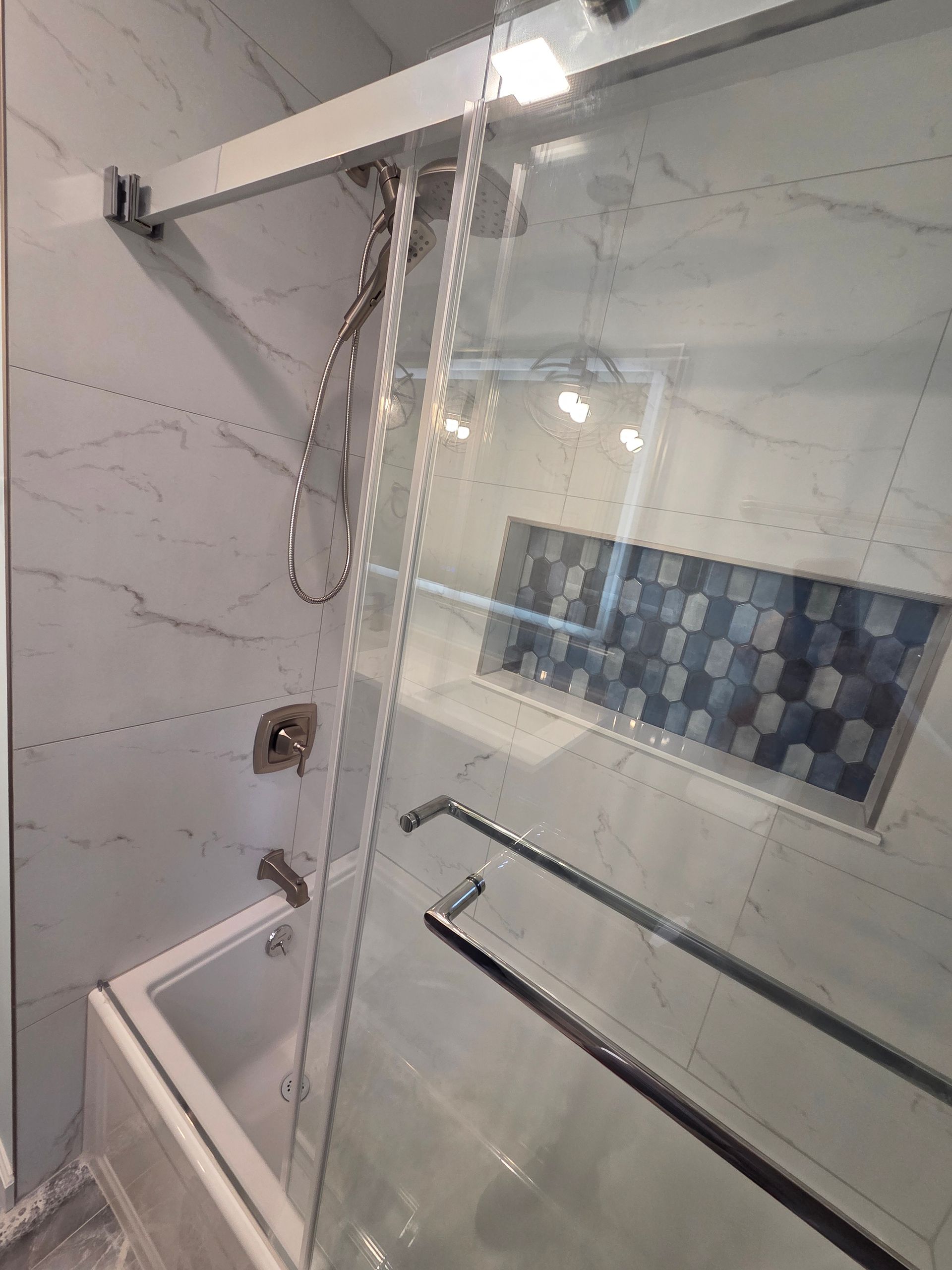 White bathroom vanity with frosted glass door panels and drawers, topped with a boat-shaped sink. Next to a white toilet.