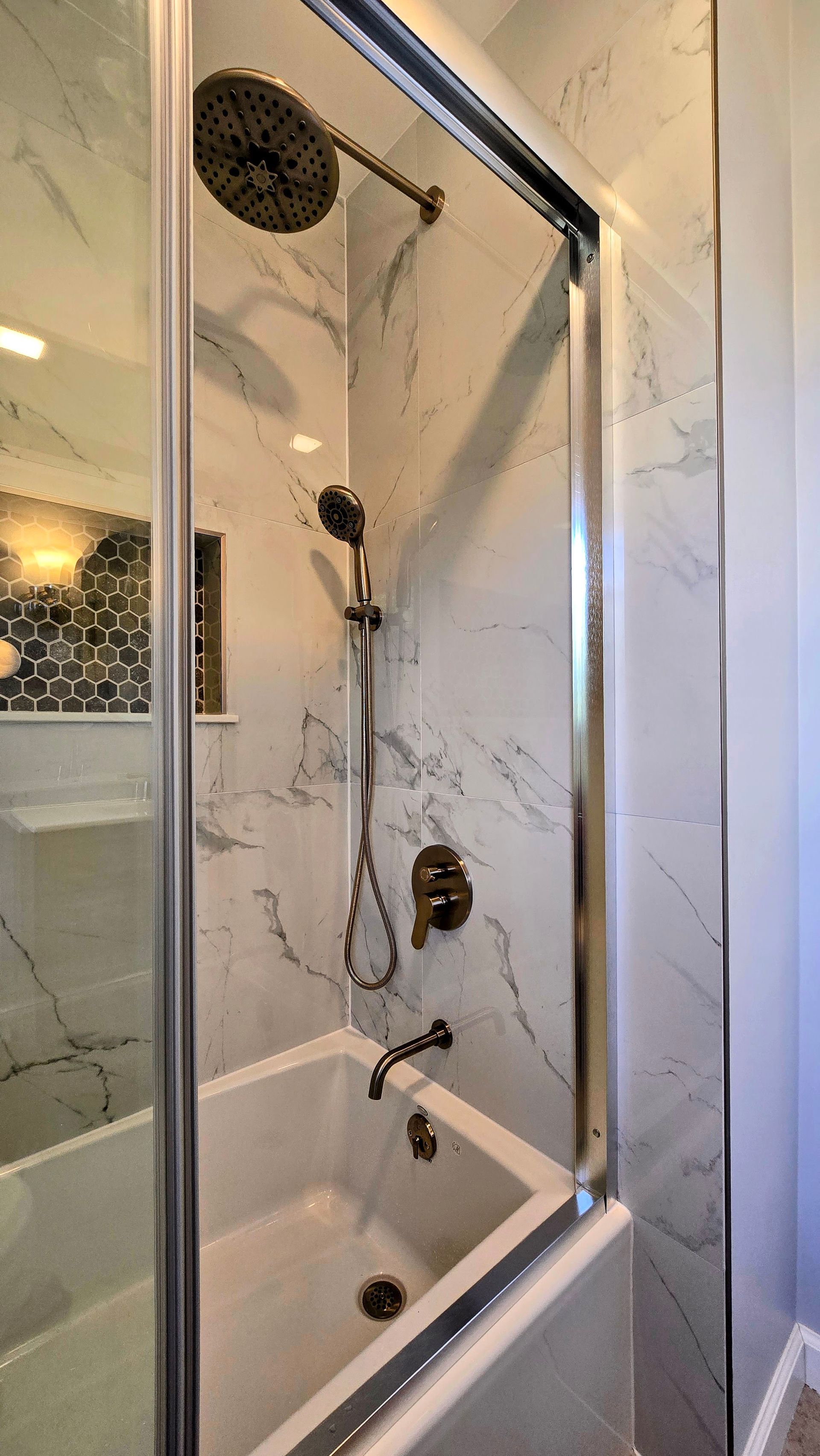 Bristol bathroom with double sinks, large mirror with lightbulbs, and a window.