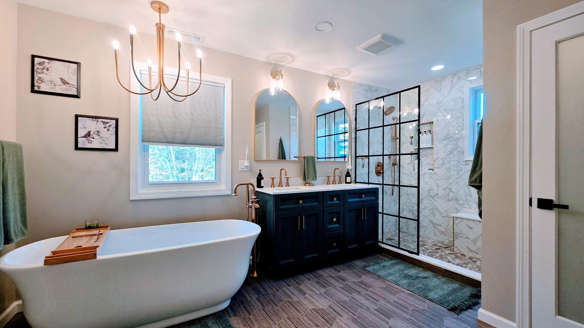 Bathroom with jacuzzi tub, vanity, toilet. Light beige walls, brown cabinets, glass shower door in Wolcott, CT