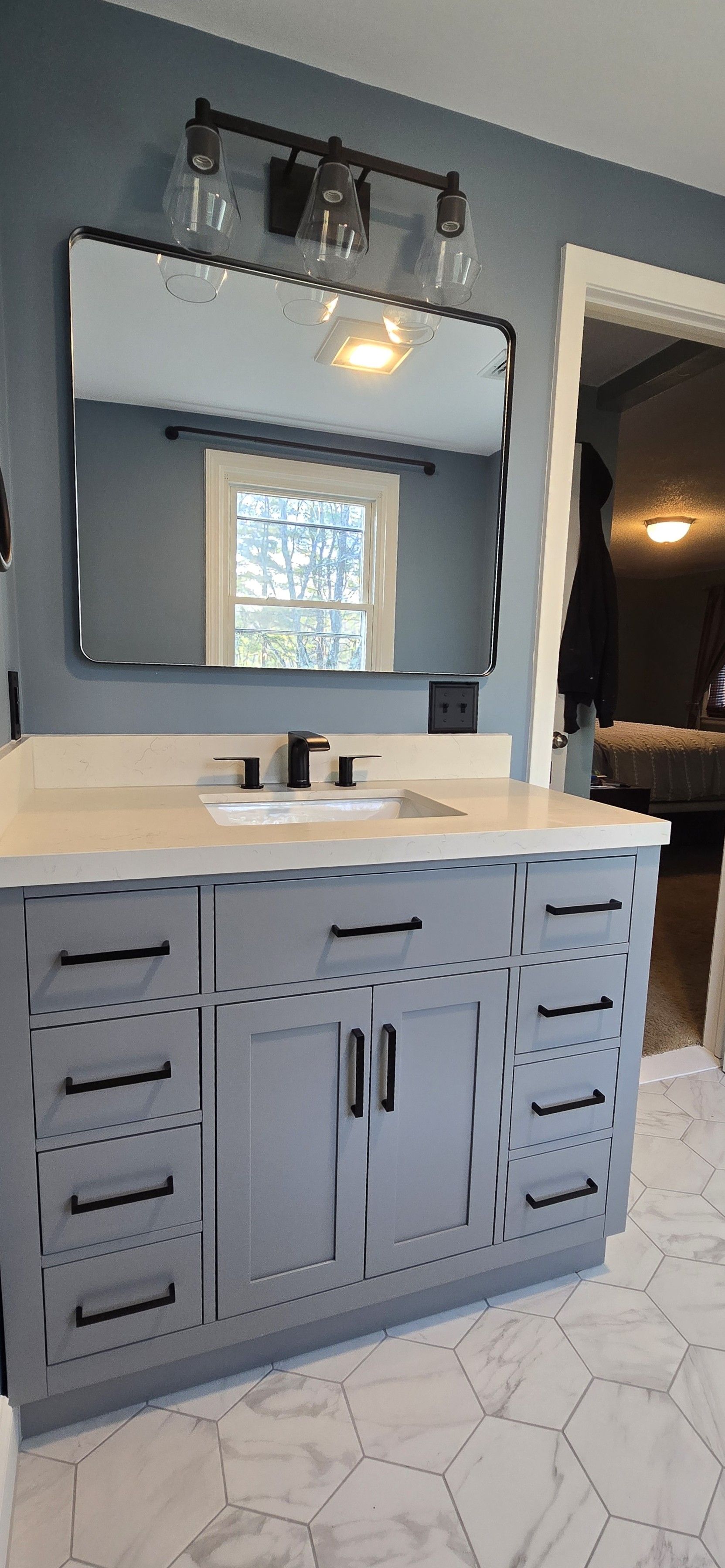 Modern Bristol bathroom vanity with a lighted mirror and black faucets.