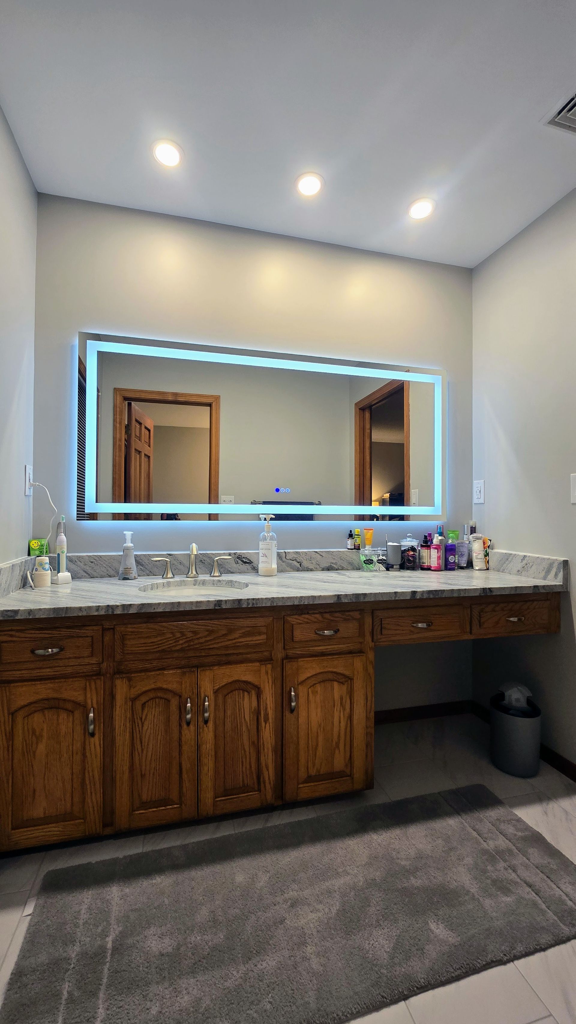 Bristol Bathroom with white bathtub, stone tile shower, black shower fixtures, recessed shelf.
