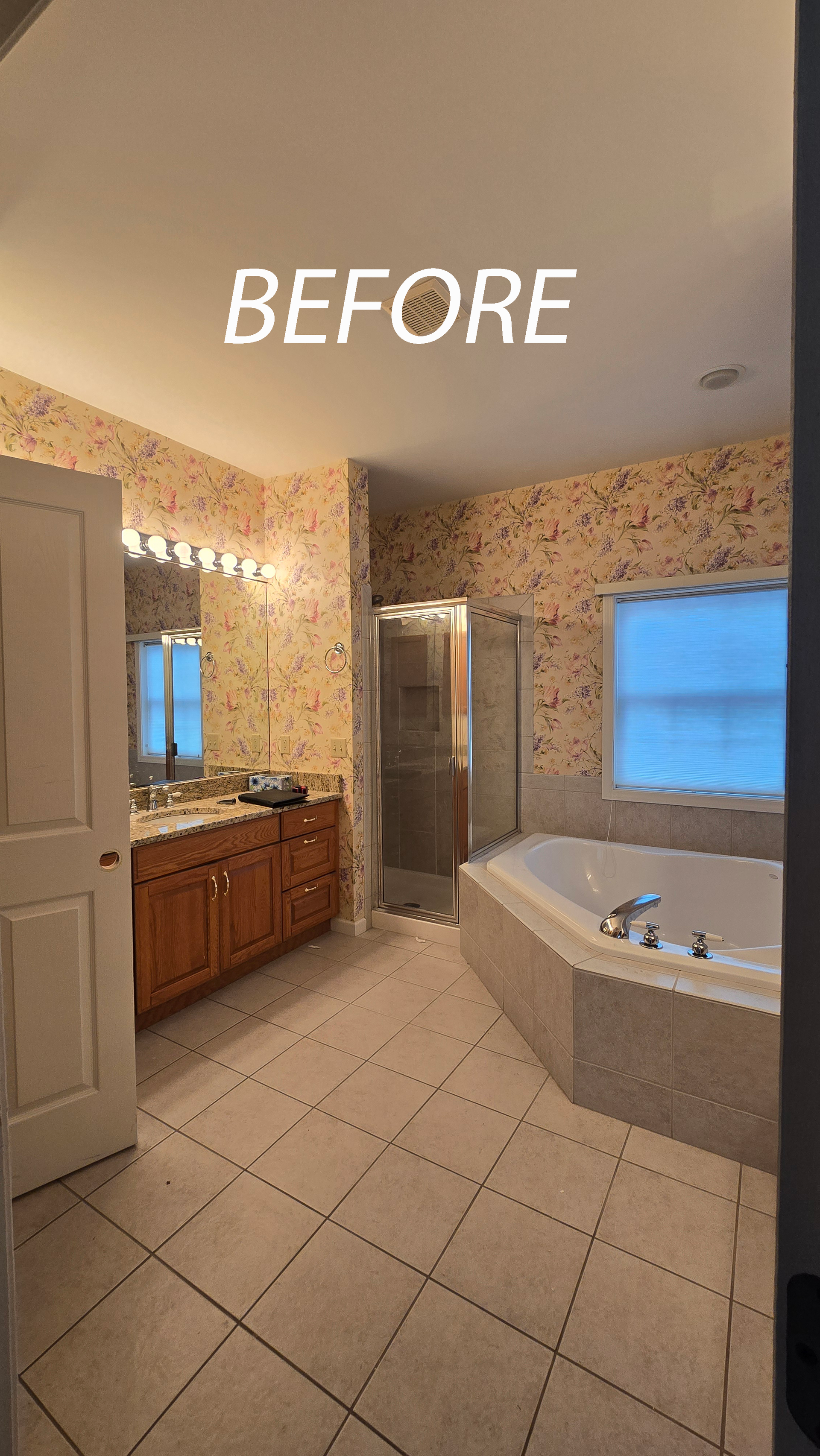 A modern bathroom in Cromwell, CT with a dark wood vanity, gold mirrors, a white soaking tub, and a walk-in shower with marble-look tiles.