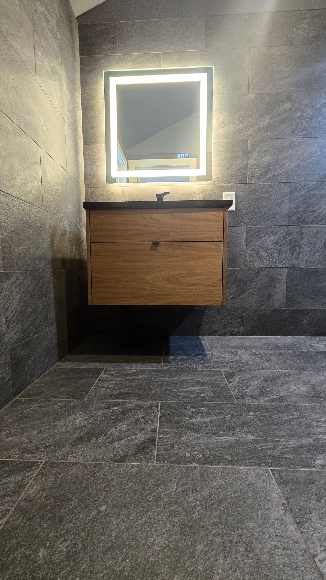 Bristol Bathroom with white bathtub, stone tile shower, black shower fixtures, recessed shelf.