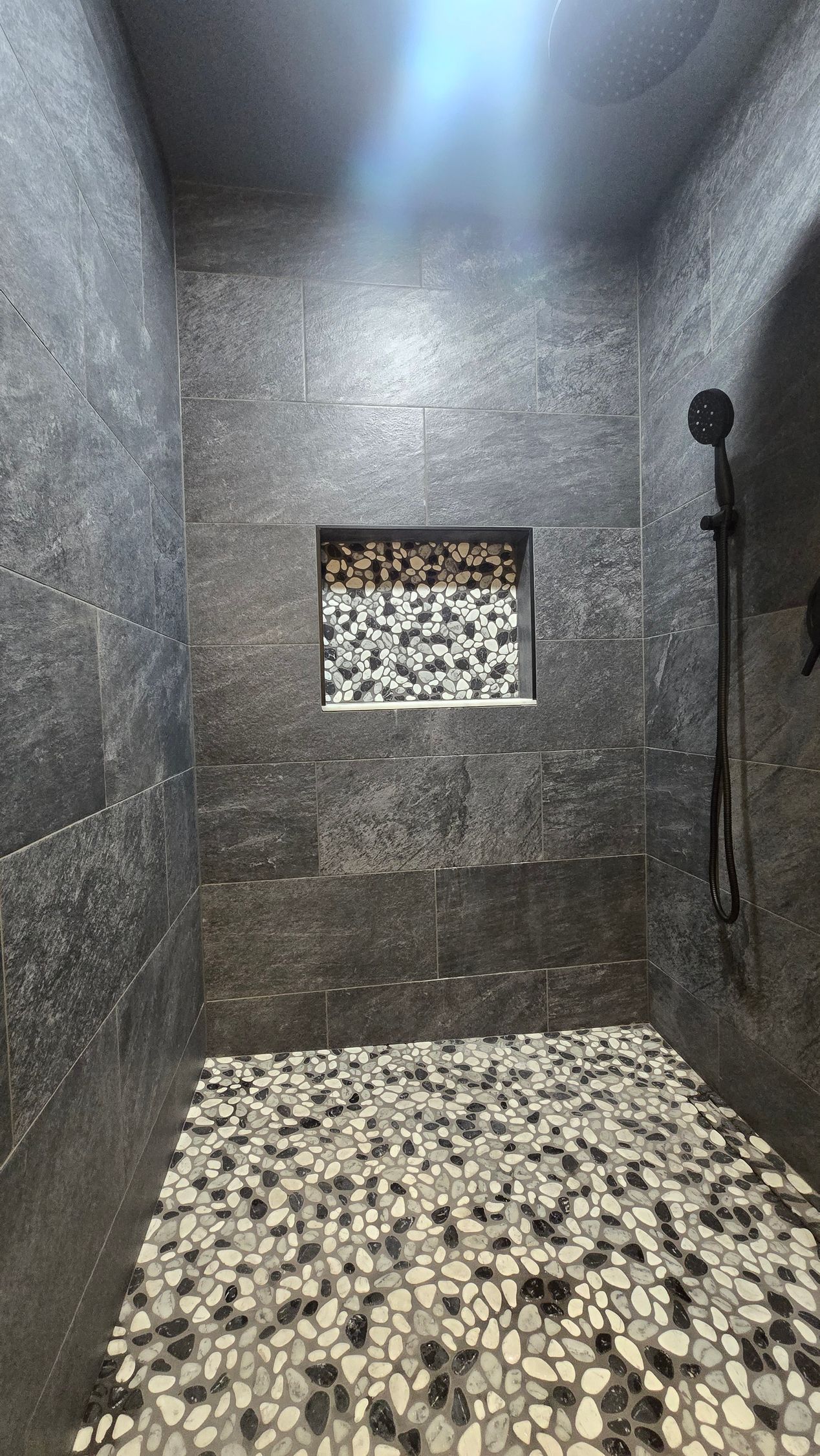 Bristol bathroom vanity with black fixtures, lit mirror, and neutral walls.