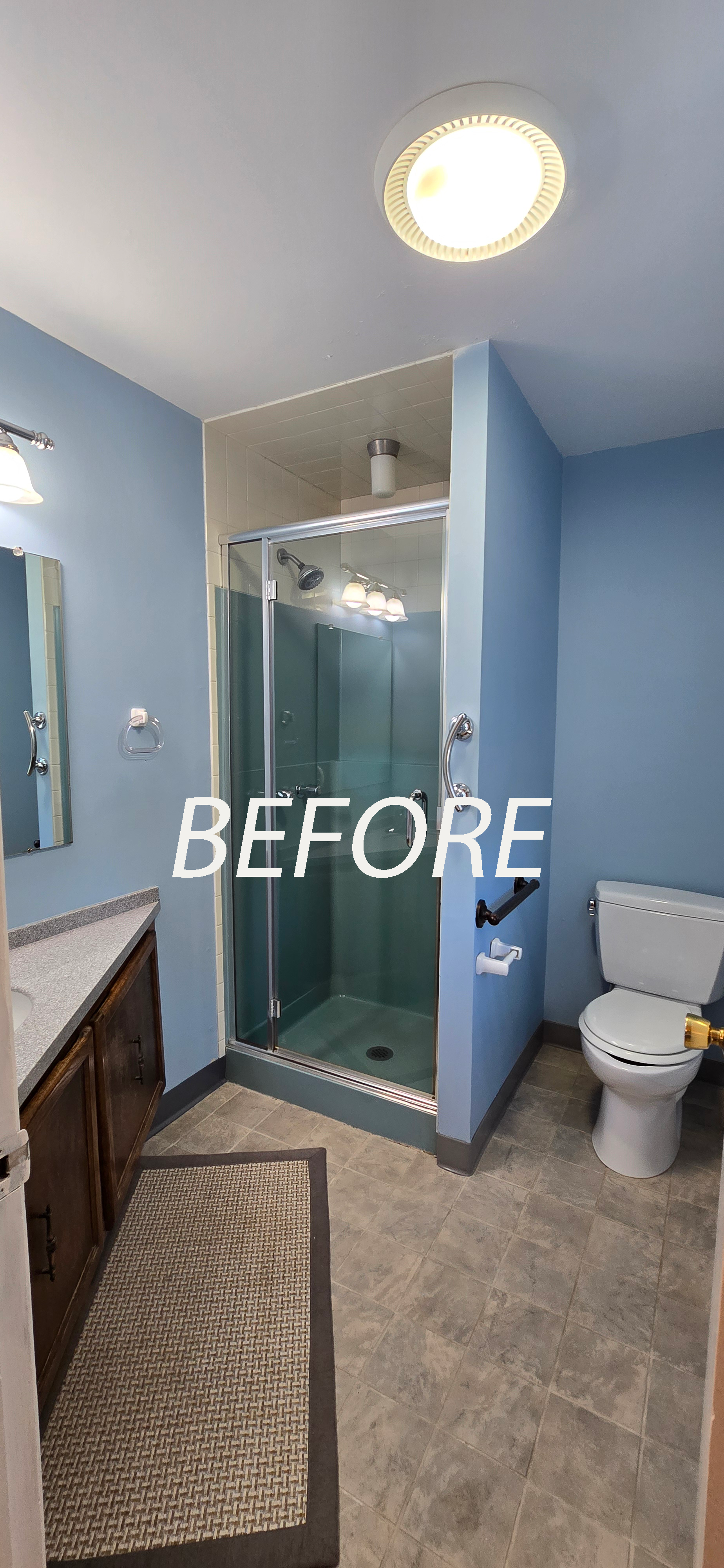 Blue-tiled bathroom in Glastonbury, CT with shower, toilet, sink, and floor mat, labeled “BEFORE”