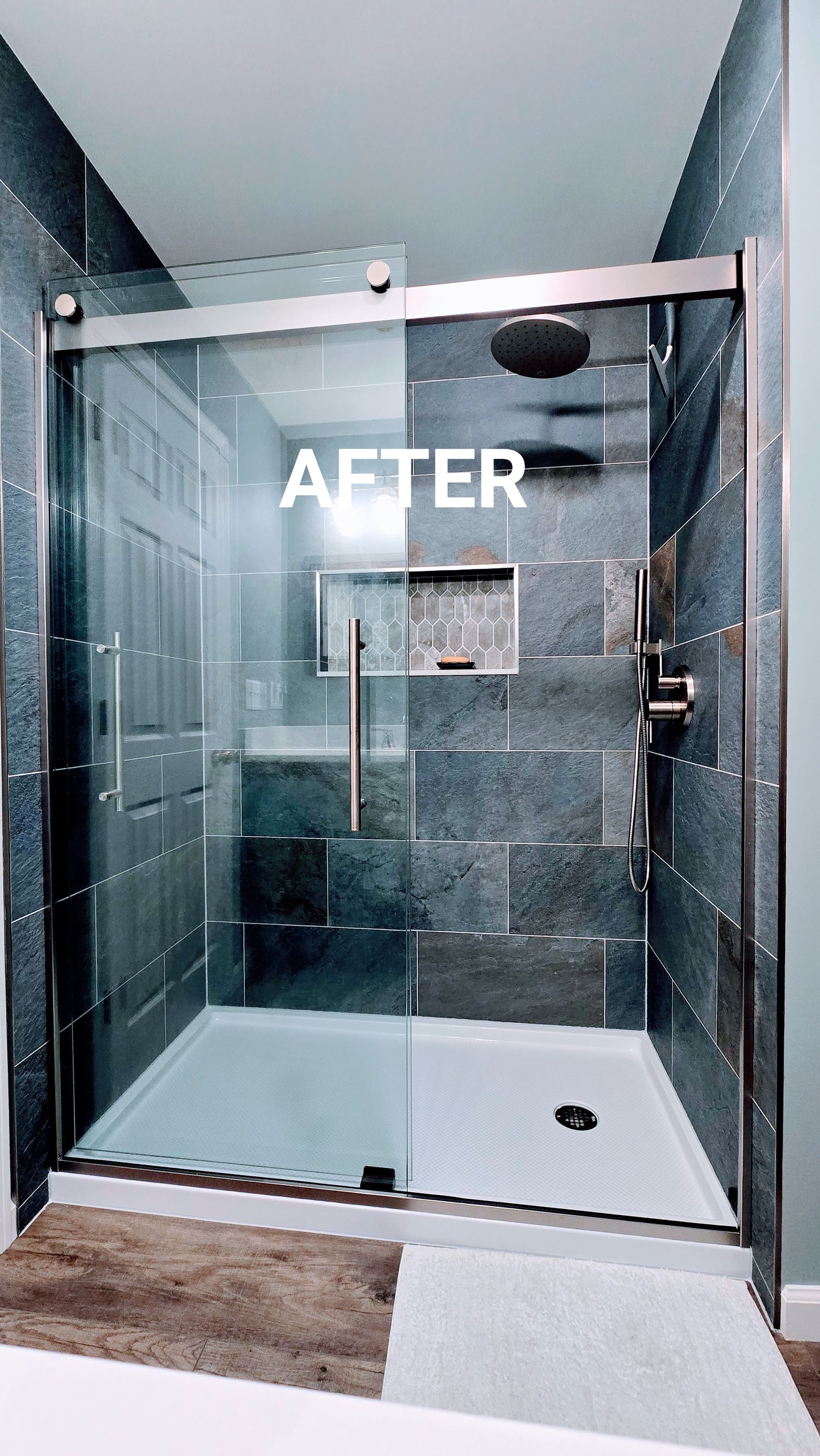 Glass walk-in shower with tiled walls, rainfall showerhead, and black fixtures in a modern bathroom. By First Choice Bathroom Remodeling done in Plainville CT.