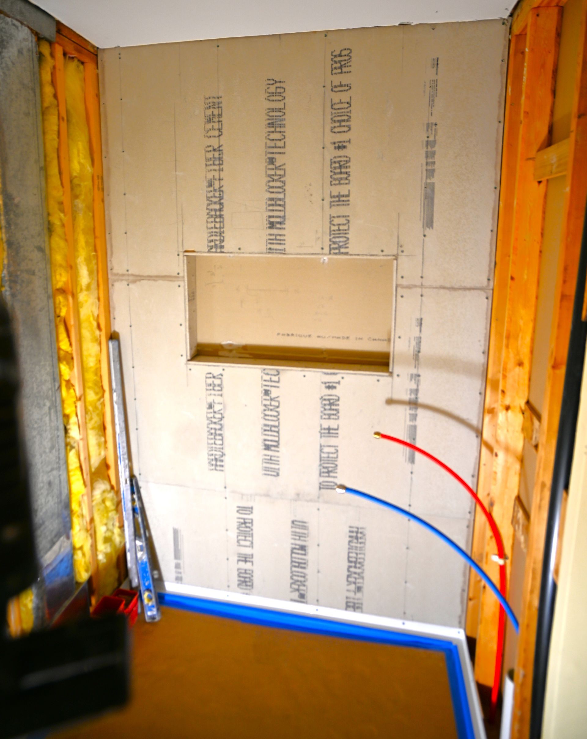 A corner of a room with a wall that has a hole in it