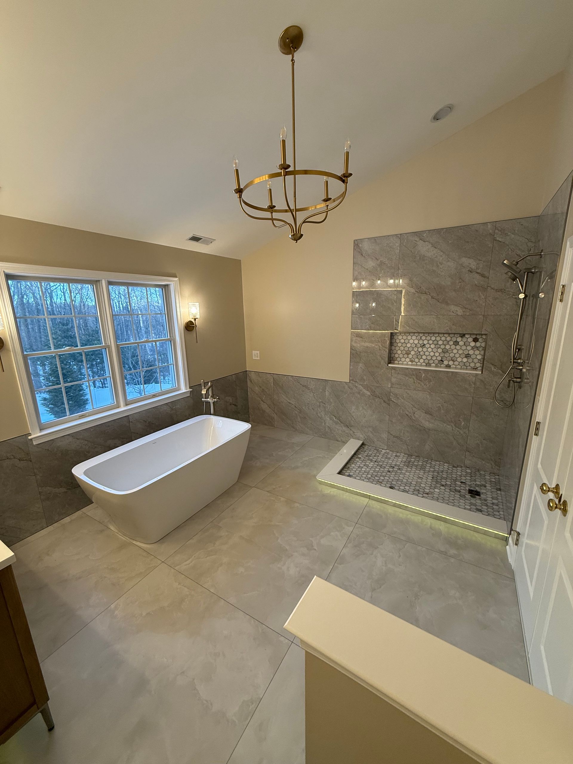 A bathroom with a bathtub and a shower.