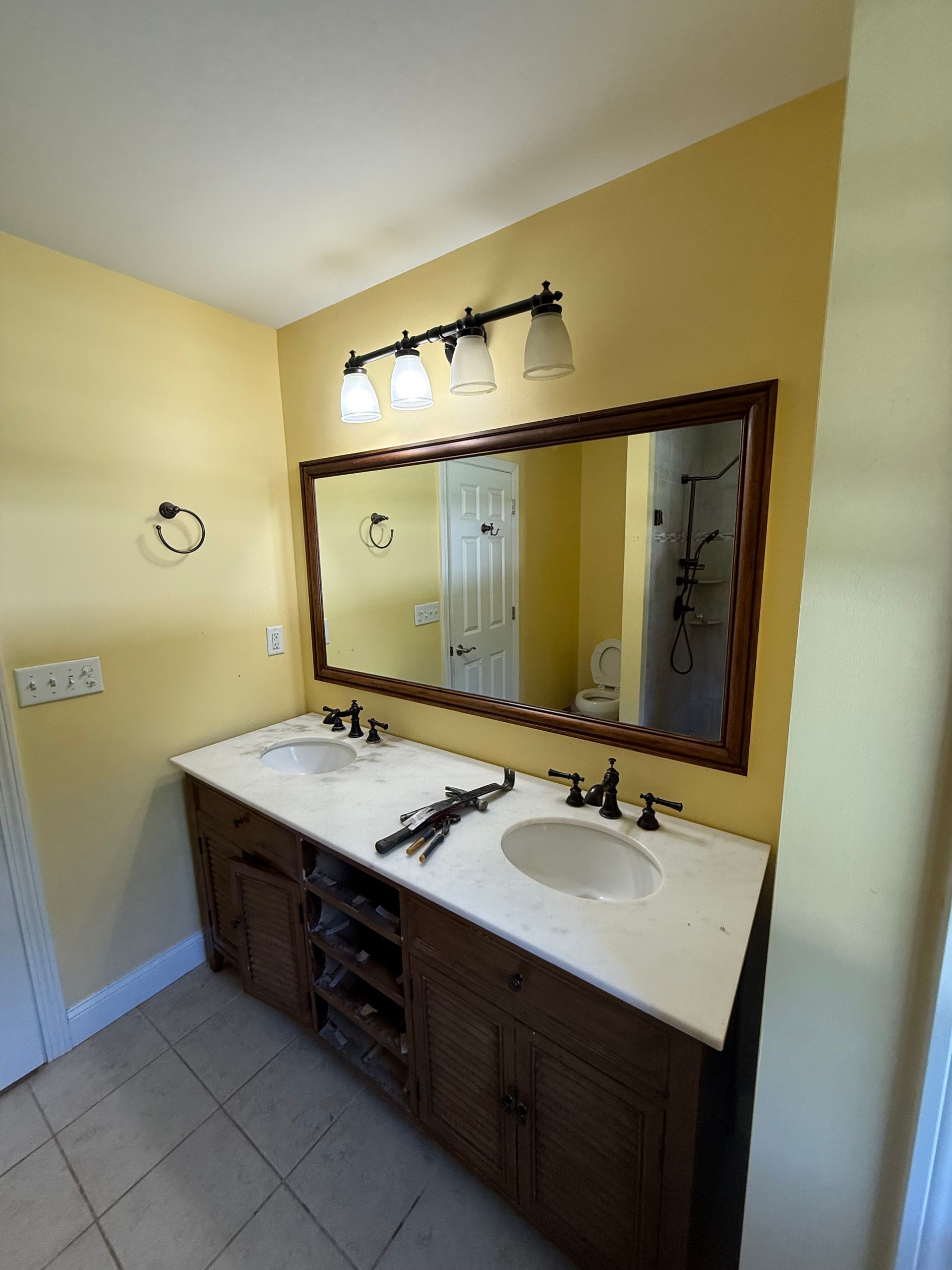 A bathroom with a walk in shower and a sink