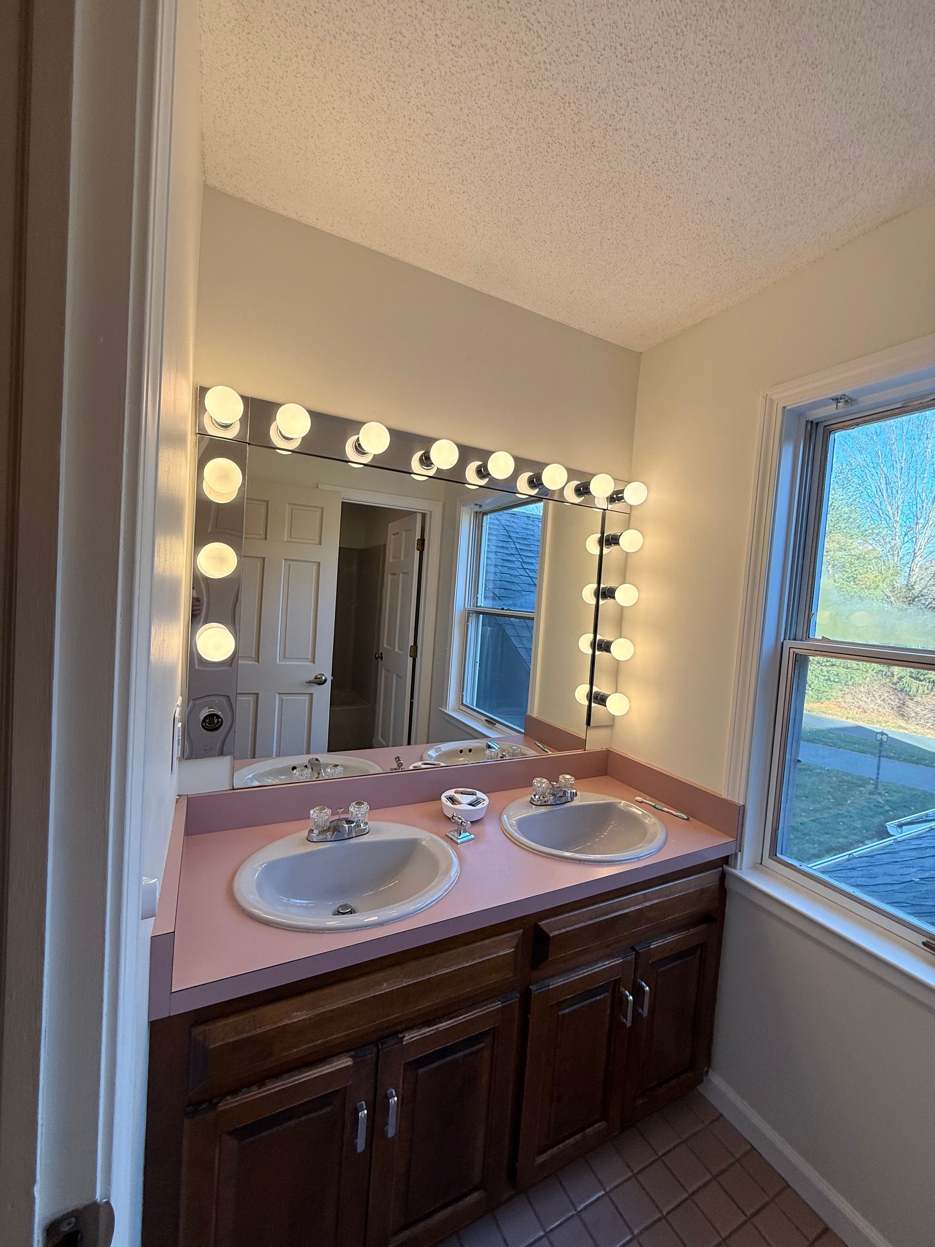 The before Bathroom remodel in Wolcott, CT with a tub, toilet, vanity, and closed door.