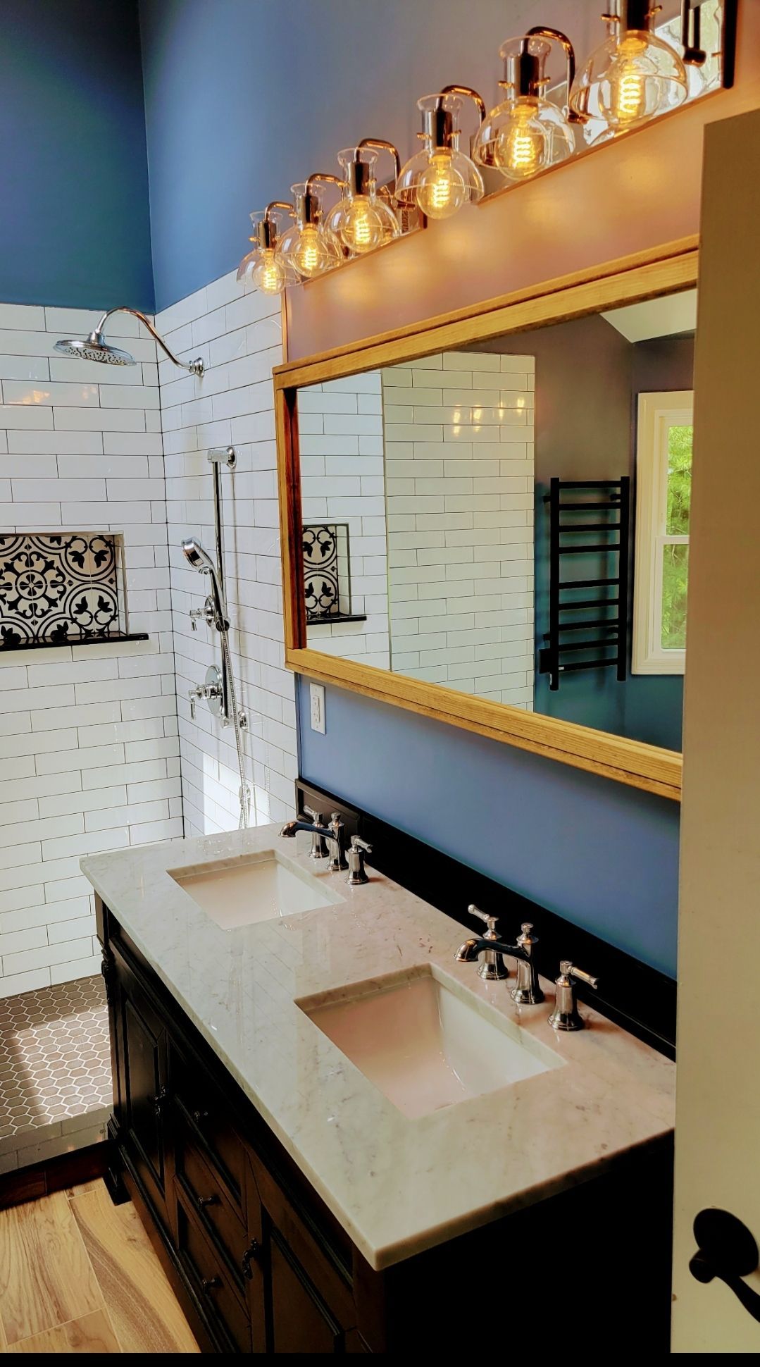 A bathroom with two sinks and a large mirror.