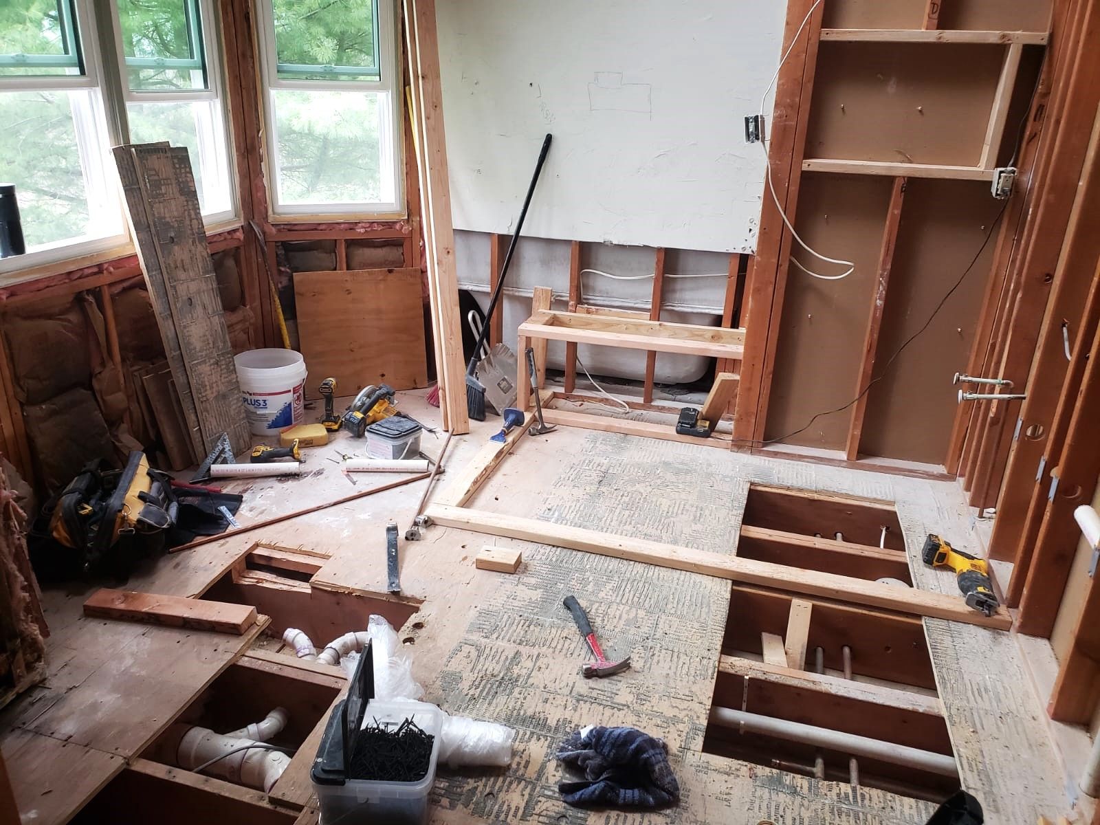 A bathroom under construction with a lot of tools on the floor.