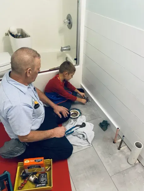 Plumber and child working Plumber and child working