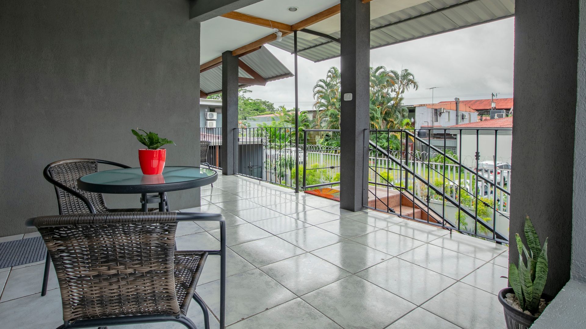 there is a table and chairs on the balcony .