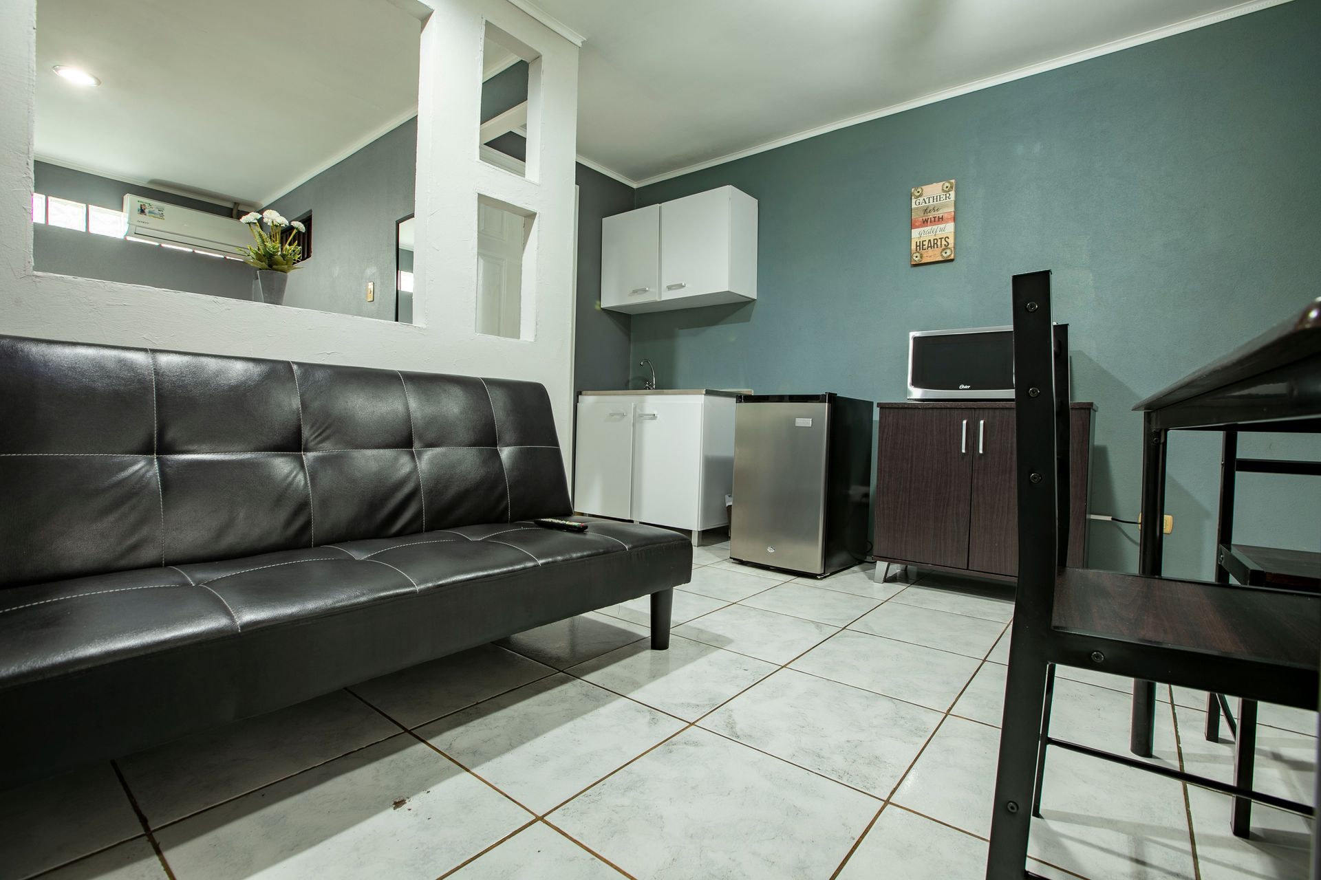 a living room with a black couch and a table