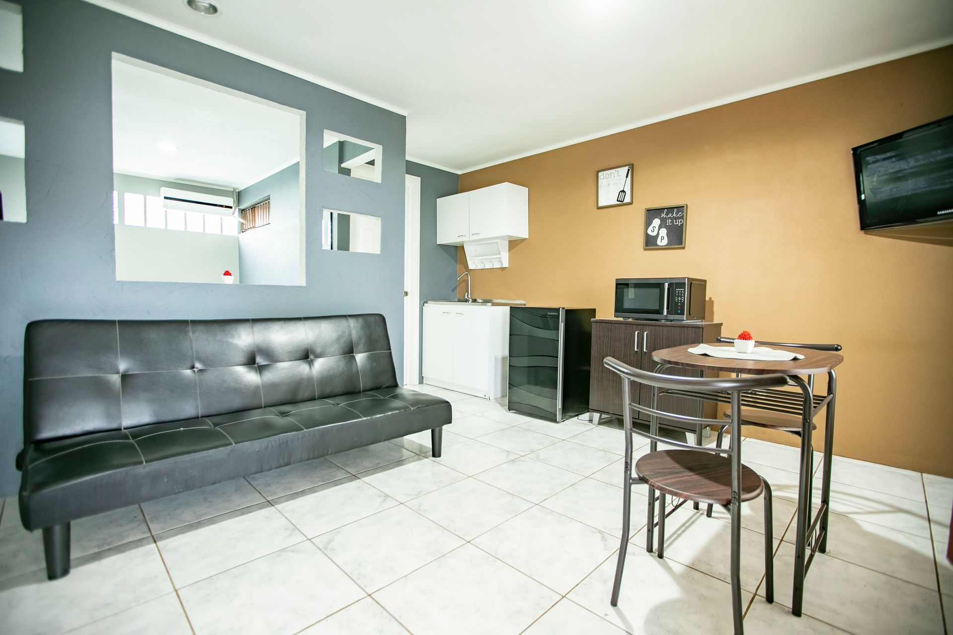 a living room with a couch , table and chairs .