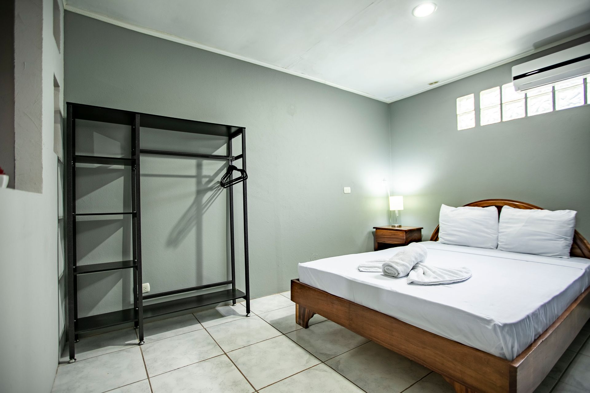 a bedroom with a king size bed and a closet