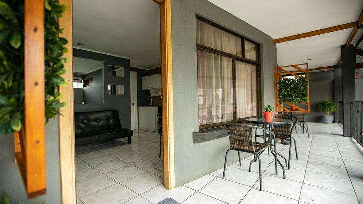 a balcony with a table and chairs and a couch .