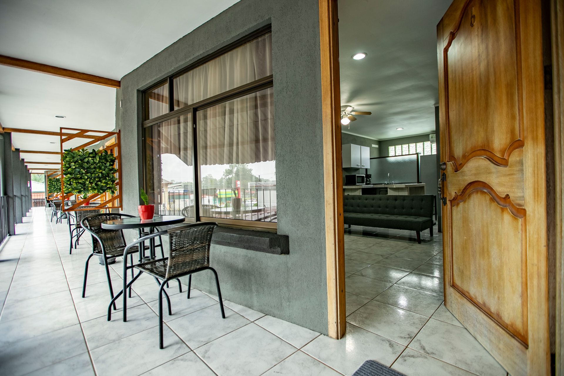 a balcony with a table and chairs in front of a building .