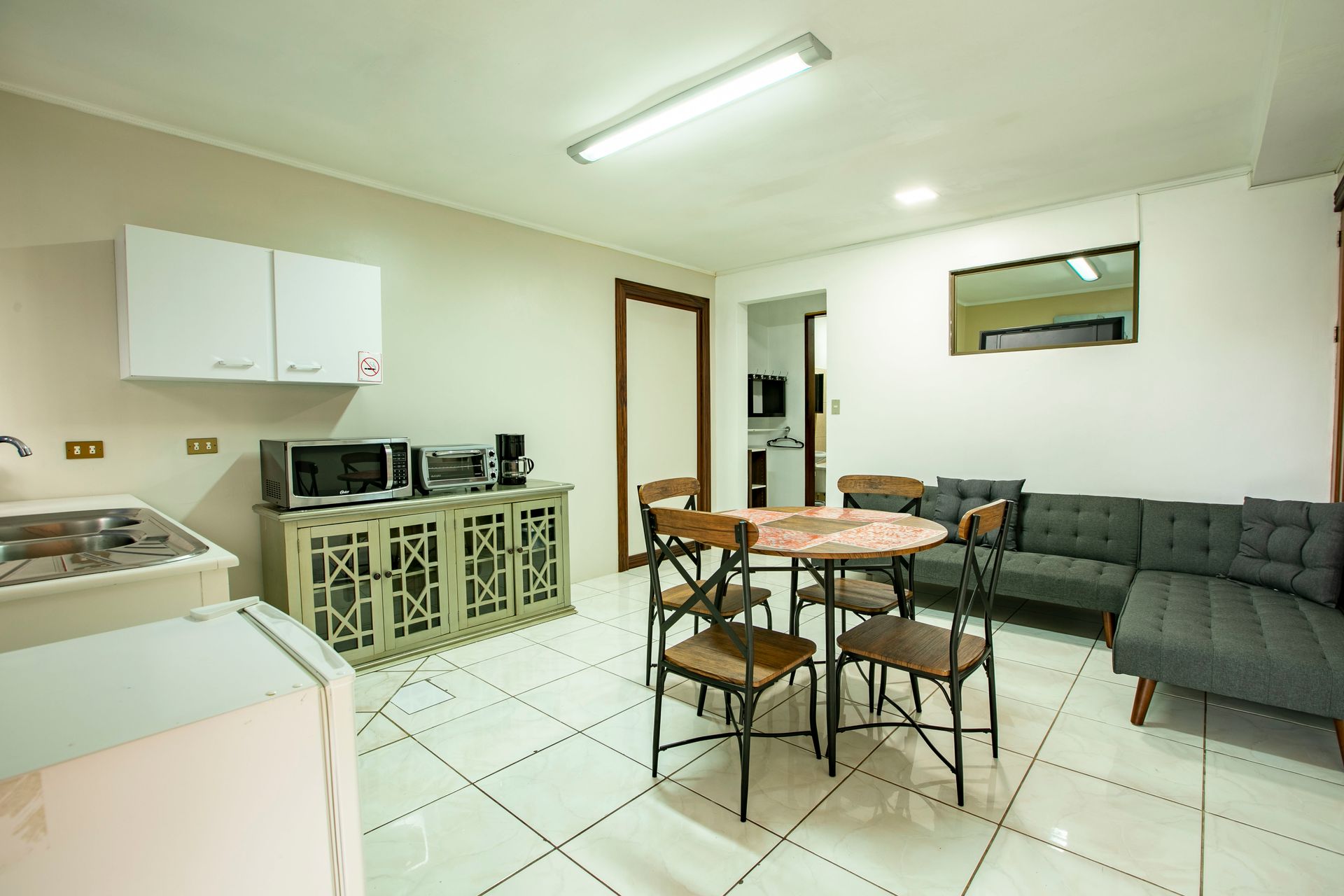 a living room with a table and chairs and a couch .