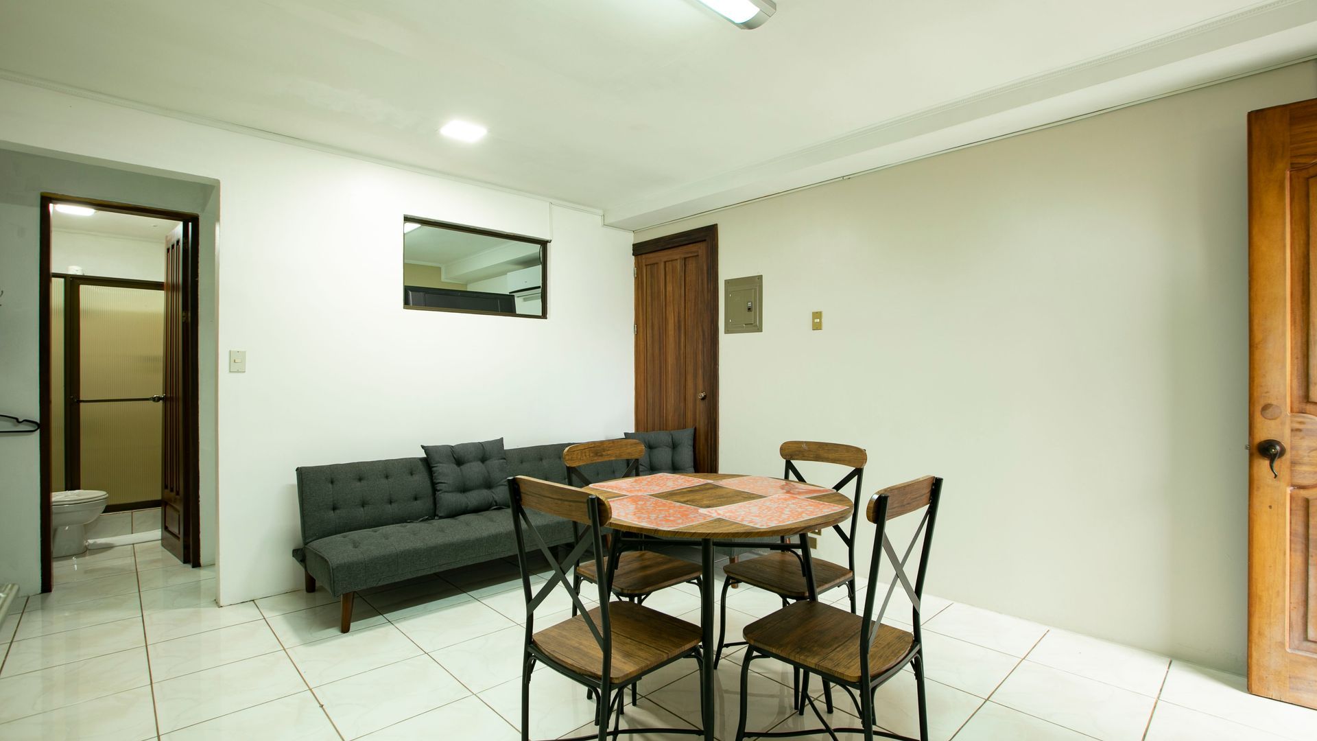 a living room with a table and chairs and a couch .