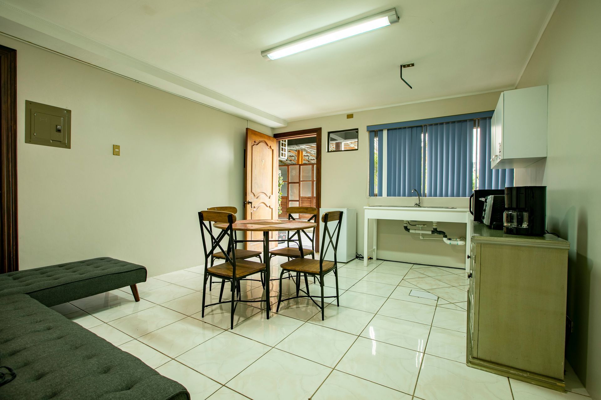 a living room with a table and chairs in it