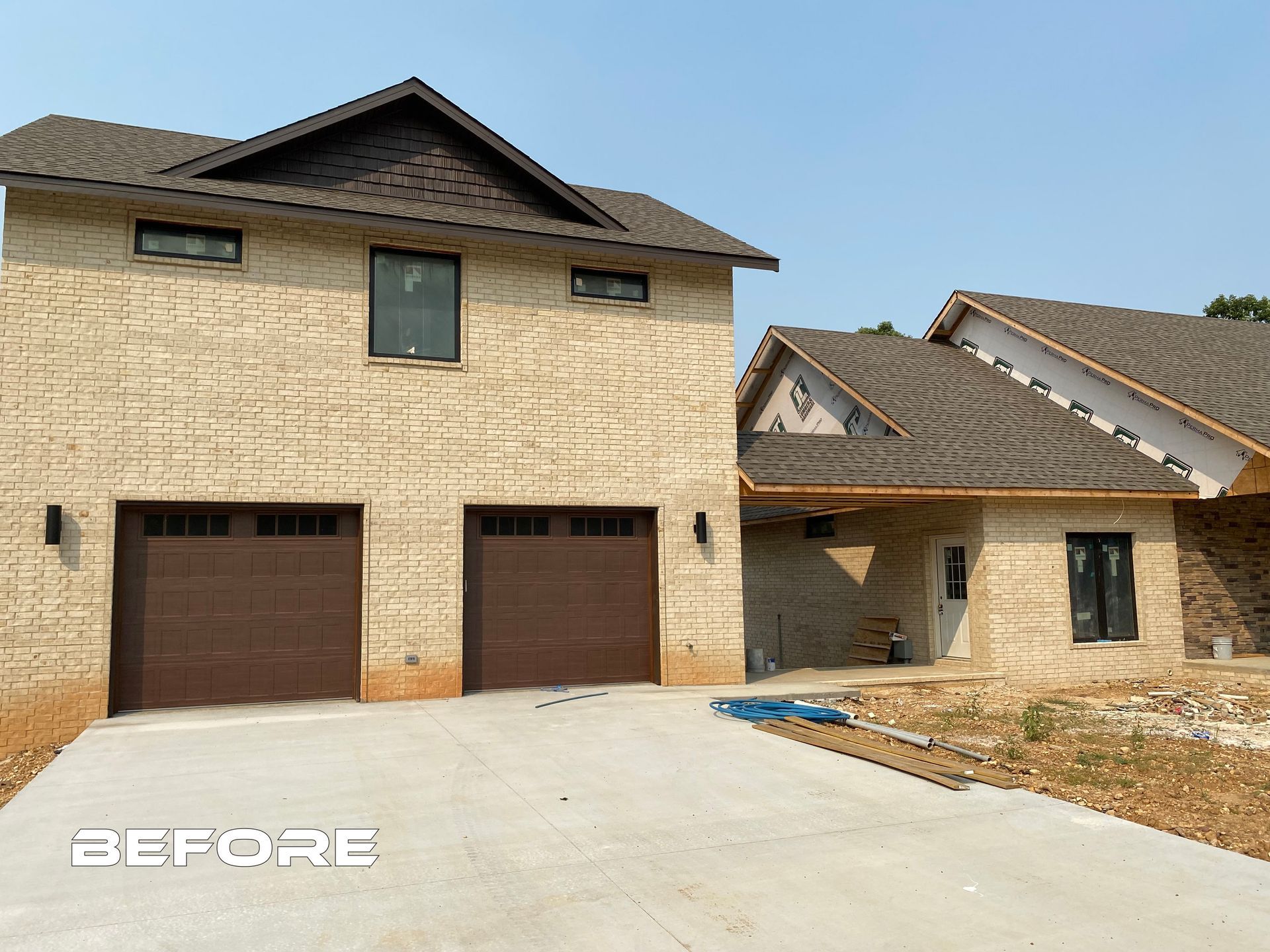 A before picture of a house with two garage doors