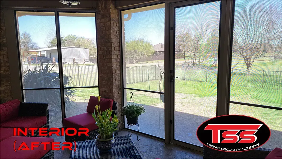 A living room with a lot of windows and a screened in porch.