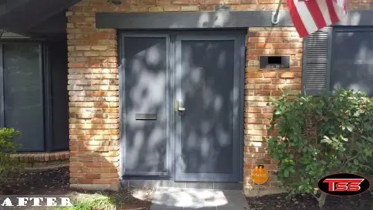 The front door of a brick house has been spray painted.
