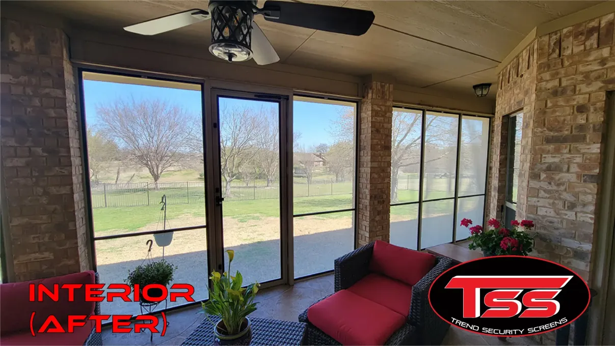 A screened in porch with a view of a lake