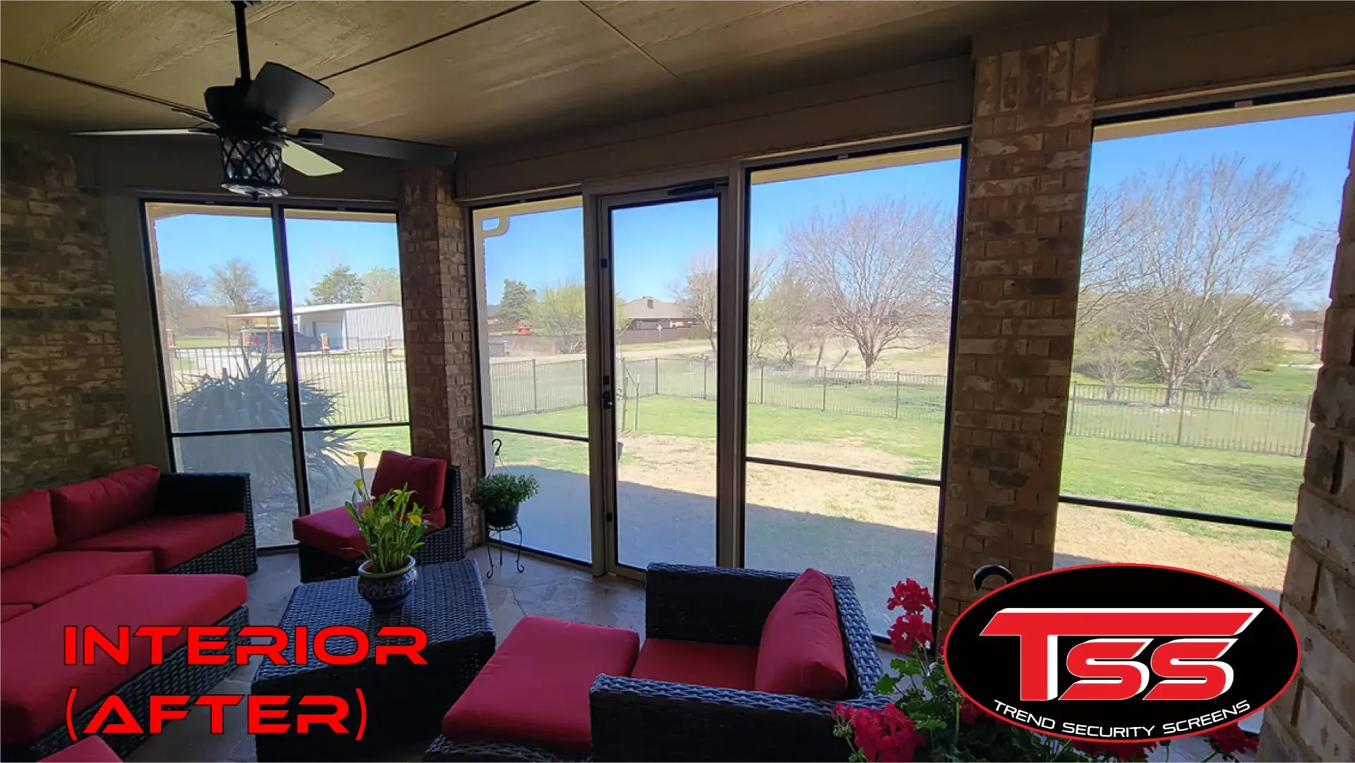 A living room with a lot of windows and a ceiling fan.