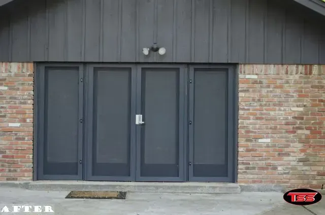 A picture of a brick building with a black door
