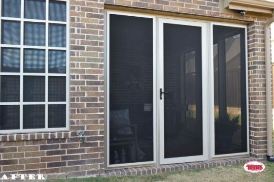 A picture of a brick house with a screen door