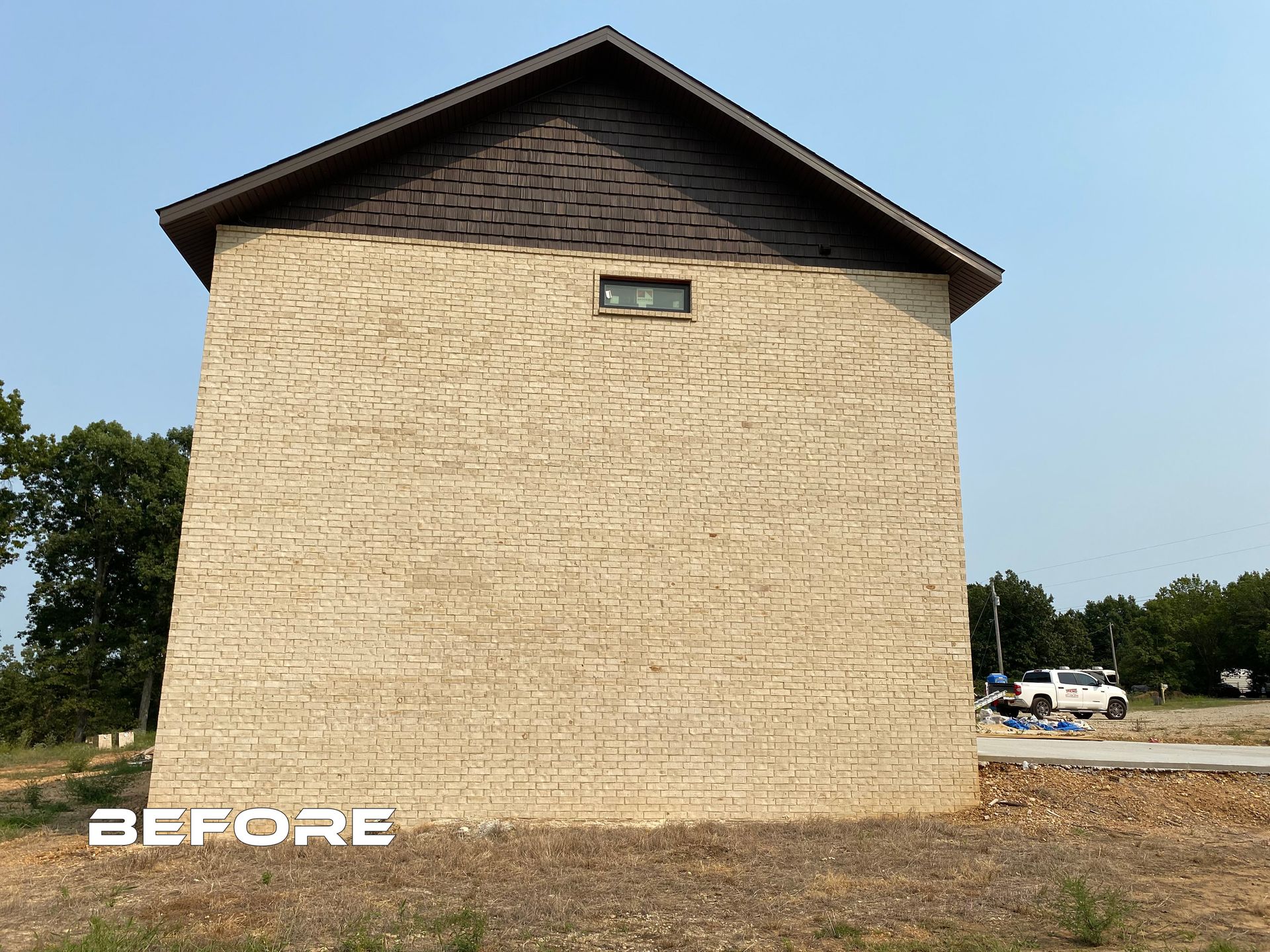 A before picture of a brick building with a roof