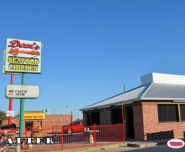 A sign for dave 's seafood chicken is above a brick building