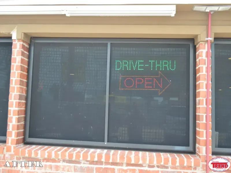A drive thru sign is displayed in a window