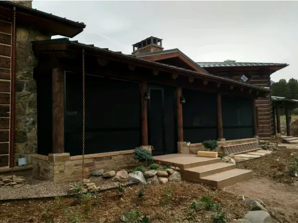 A large house with a screened in porch and stairs