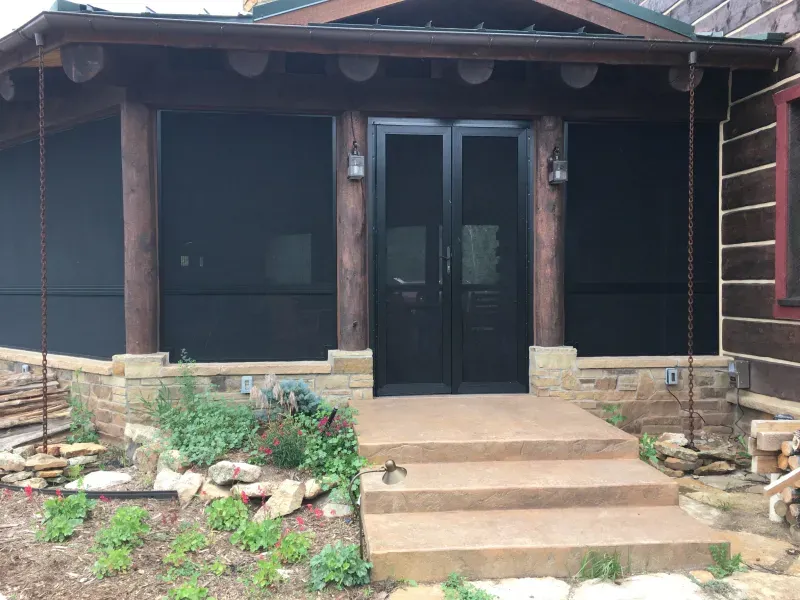A house with a screened in porch and stairs