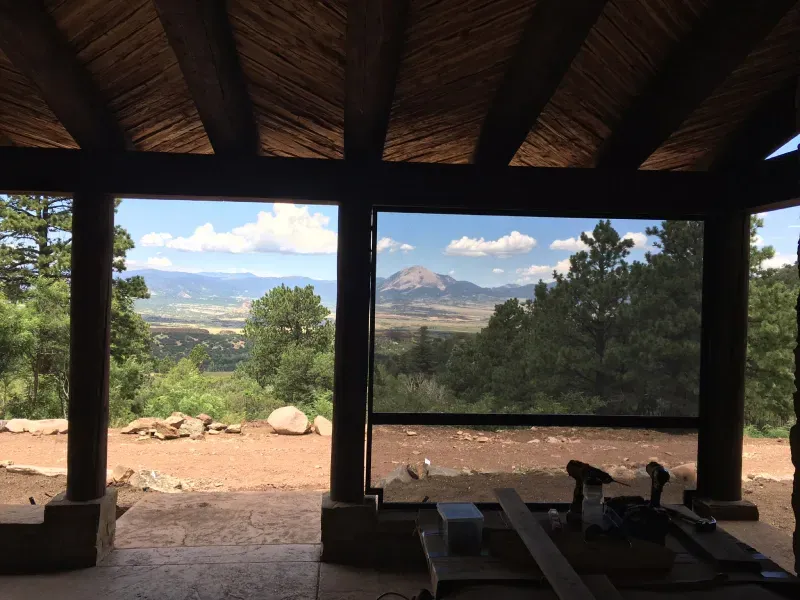 A gazebo with a view of mountains and trees