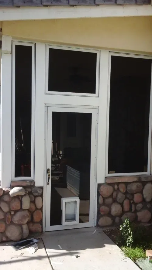 A screened in porch with a dog door