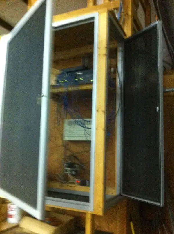 A cabinet with a screen door that is open