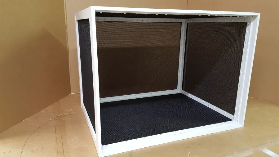 A white box with a black screen is sitting on a table.
