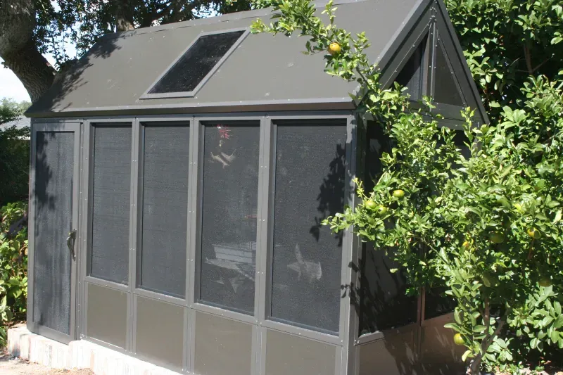 A screened in porch with a solar panel on the roof