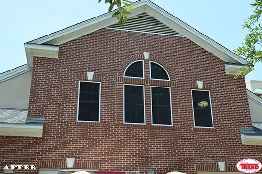 A brick building with arched windows and a sign that says after